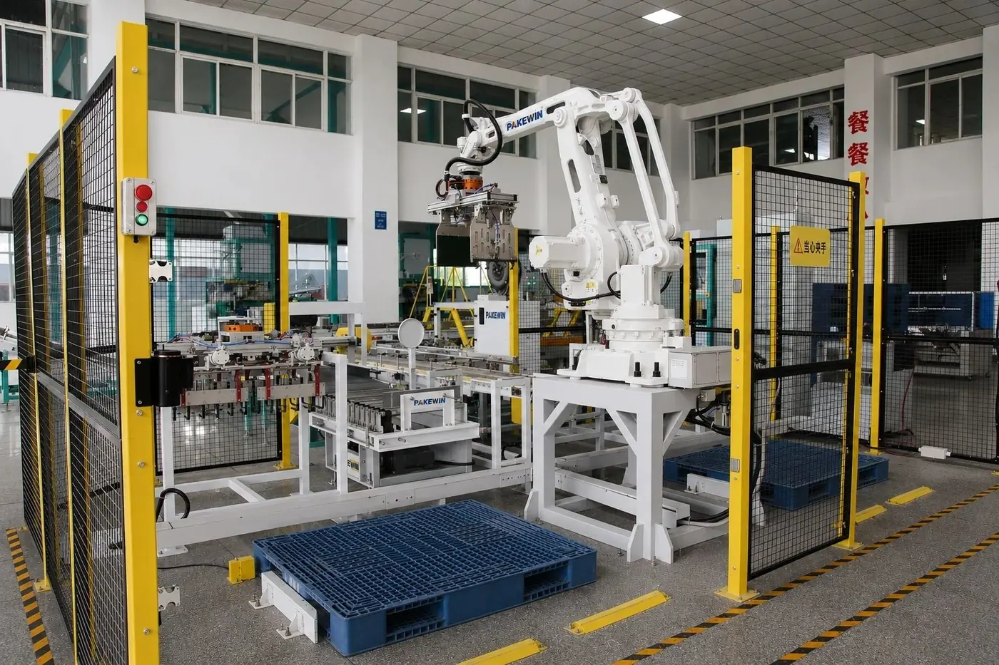 A real PAKEWIN robotic palletizing cell with guarding, conveyors and pallet positions.
